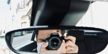 person holding black camera lens