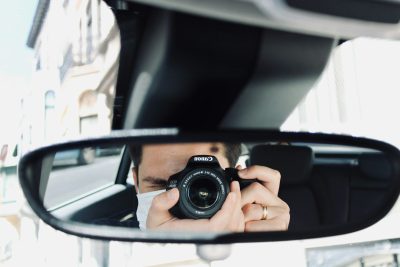 person holding black camera lens