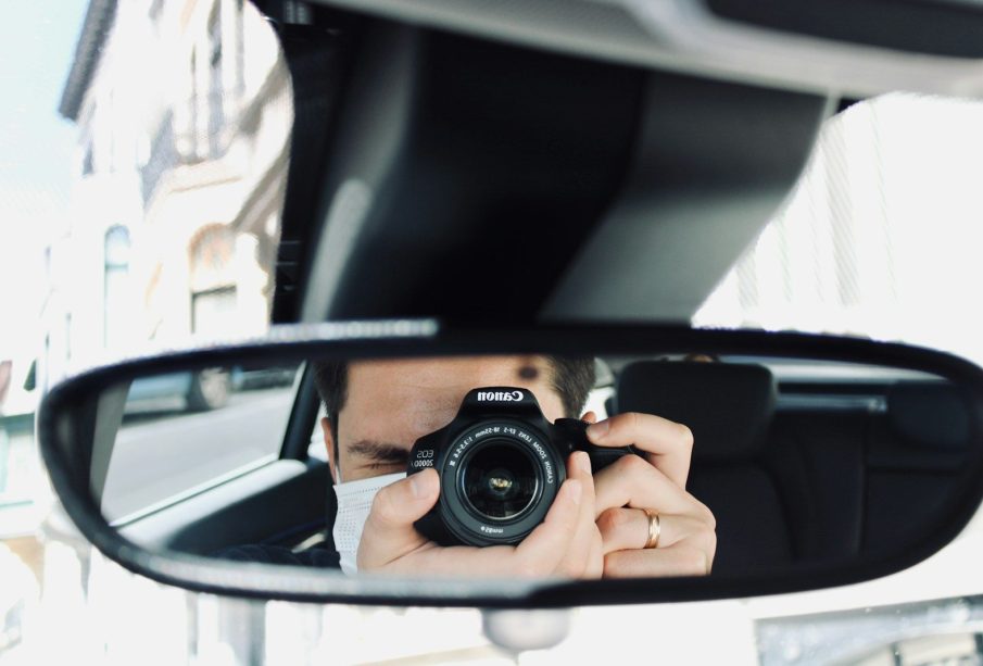 person holding black camera lens